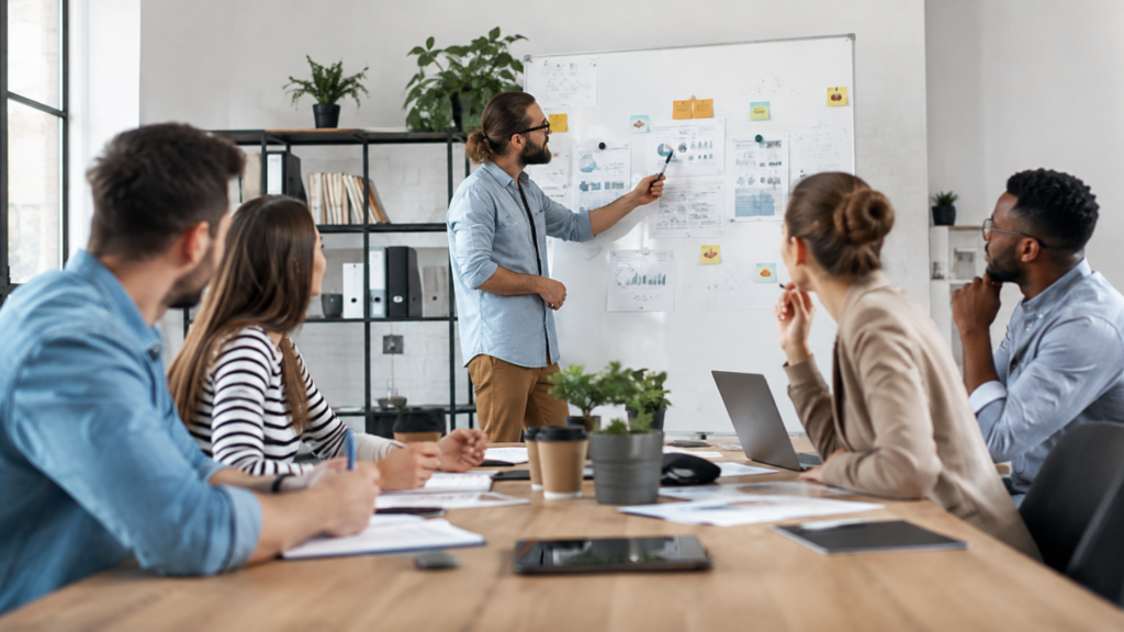 Marketing agency team collaborating on a digital marketing strategy during a meeting in a modern office.